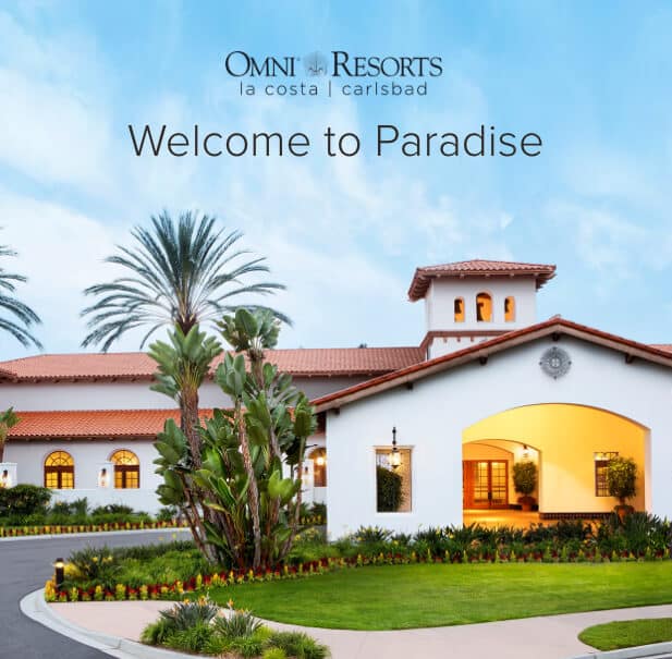 Exterior of La Costa Resort surrounded by green grass and palm trees