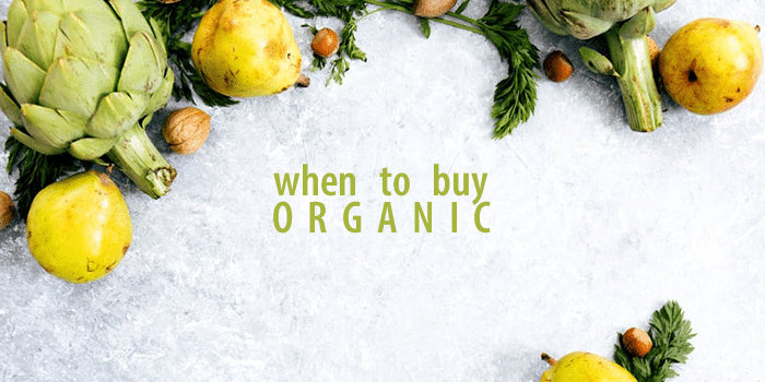 Artichoke and pears on a table surround text "when to buy organic"