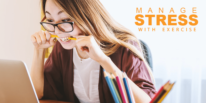 woman biting on pencil while staring at computer